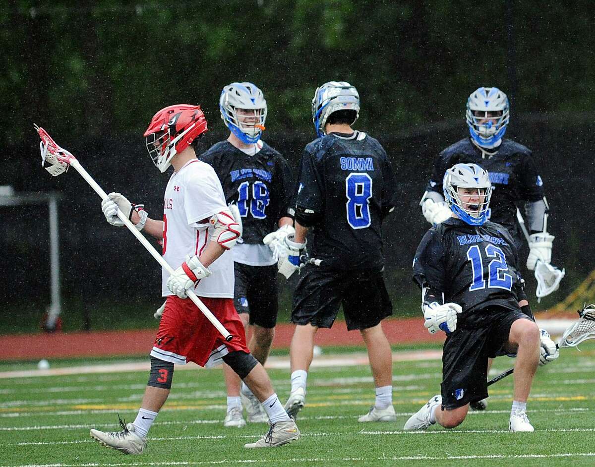 At right, Kevin Lindley (12) of Darien reacts after he scored a goal during the boys high school lacrosse game between Greenwich High School and Darien High School at Greenwich, Conn., Saturday, May 13, 2017. Second from left is Darien's Matt Meyjes (18) and next to him at right is teammate Blake Sommi (8). Darien defeated Greenwich 12-8.