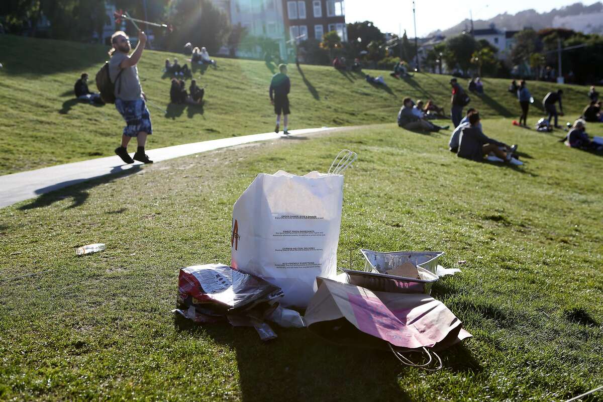 A pile of garbage left by park go-ers is seen in Dolores Park on Saturday, May 13, 2017 in San Francisco, Calif.