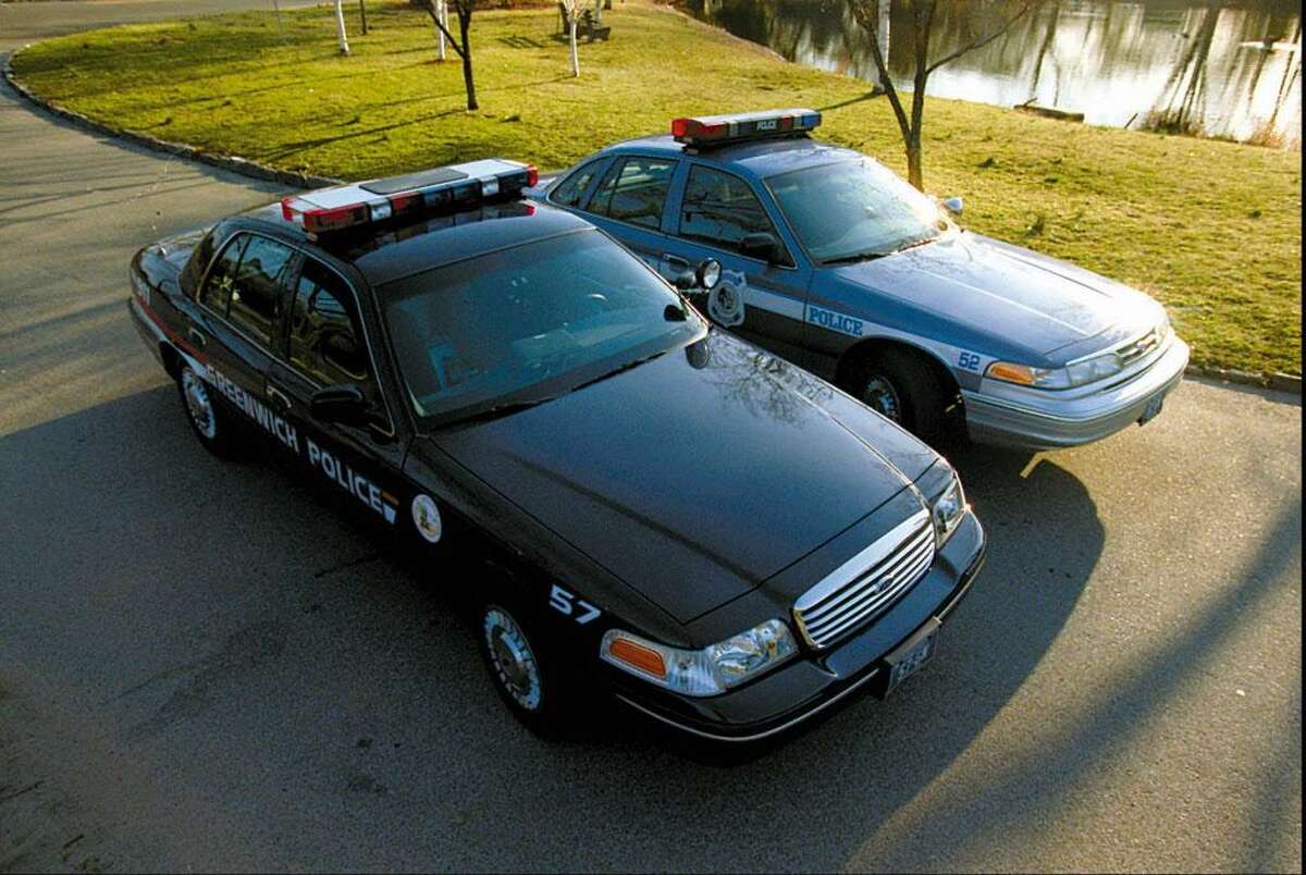 Greenwich 3.17.98 - The newer police car (in foreground), with the older car in background. Some things not obvious in the photo is the fact that the lights are much brighter than the previous model. Photo/Mel Greer COLOR