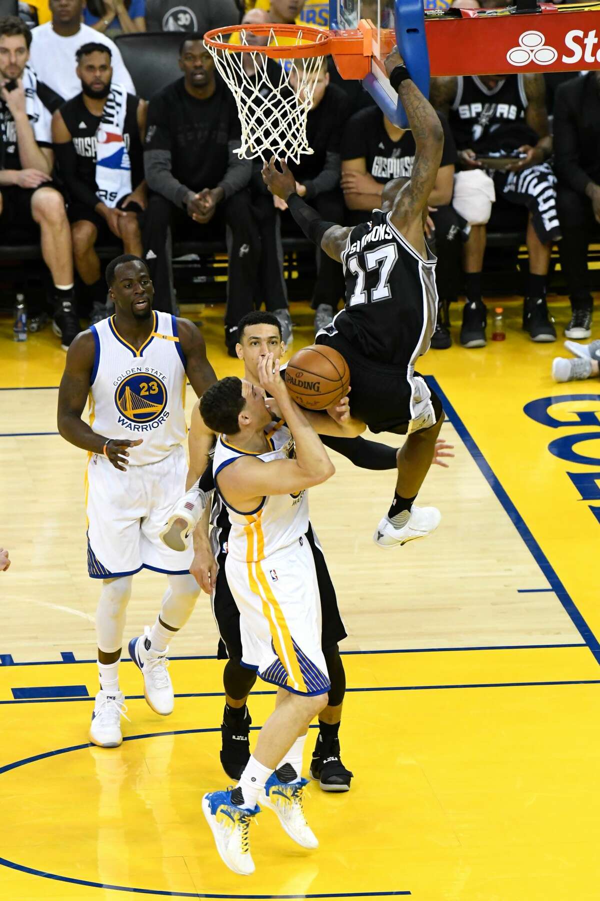 OAKLAND, CA - MAY 14: Klay Thompson #11 of the Golden State Warriors is fouled by Jonathon Simmons #17 of the San Antonio Spurs during Game One of the NBA Western Conference Finals at ORACLE Arena on May 14, 2017 in Oakland, California. NOTE TO USER: User expressly acknowledges and agrees that, by downloading and or using this photograph, User is consenting to the terms and conditions of the Getty Images License Agreement. (Photo by Thearon W. Henderson/Getty Images)
