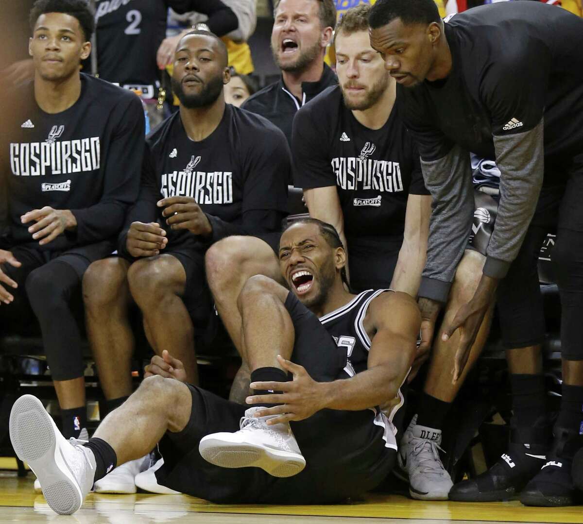 San Antonio Spurs' Kawhi Leonard reacts after being injured on a play during second half action of Game 1 in the Western Conference Finals against the Golden State Warriors Sunday May 14, 2017 at Oracle Arena in Oakland, CA. The Warriors won 113-111.