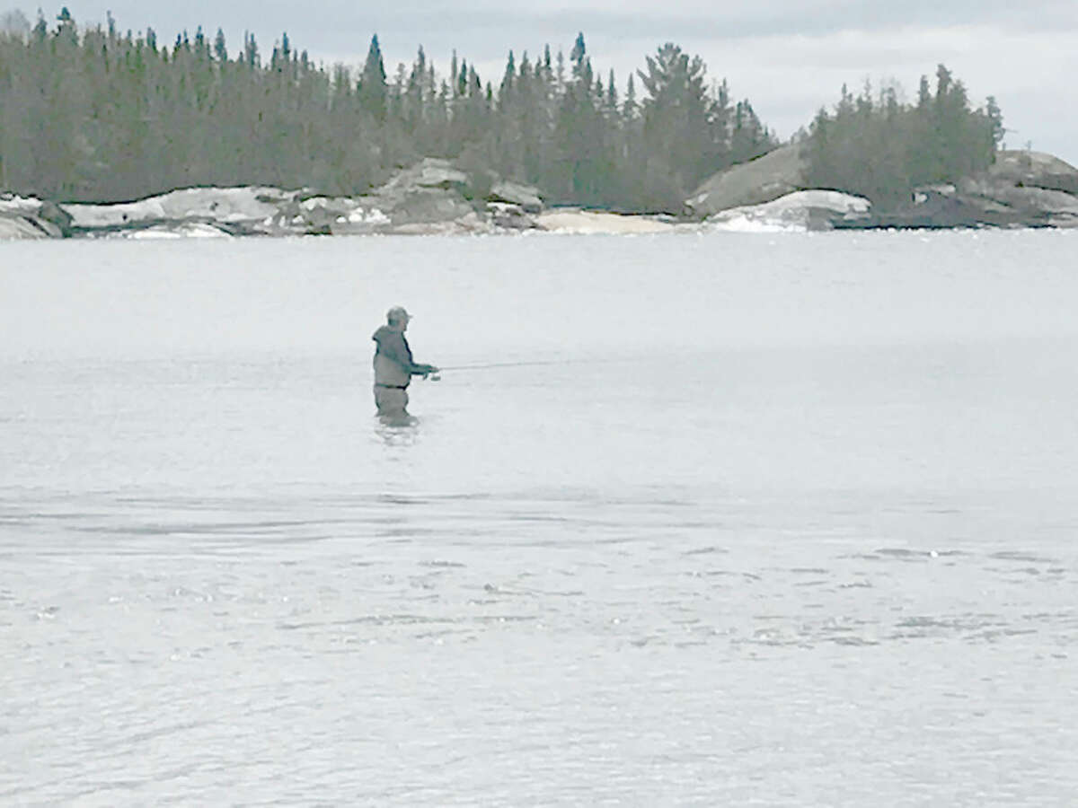 STEVE GRIFFIN | for the Daily News An angler casts a spoon, hoping that a Lake Superior steelhead will strike.