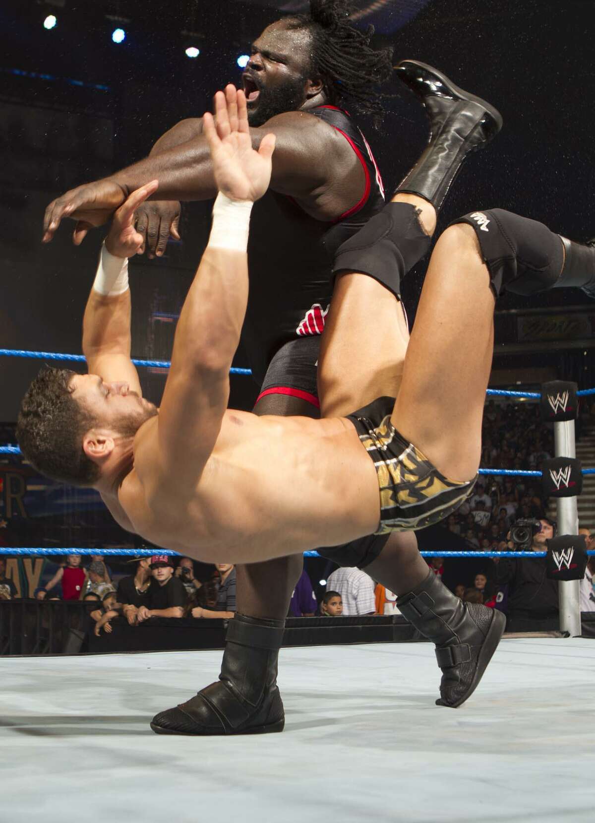 Mark Henry body slams his opponent in 2014 during a Road to WrestleMania event.