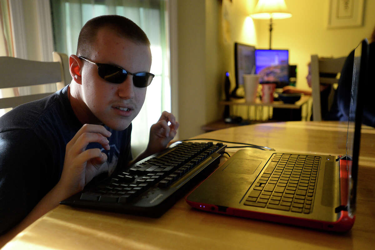 Colton Hill, 16, listens to the text-to-voice software on his computer at his family's home in Vidor on Wednesday evening. Hill, who is blind, uses his computer to compose electronic dance music. Photo taken Wednesday 5/10/17 Ryan Pelham/The Enterprise