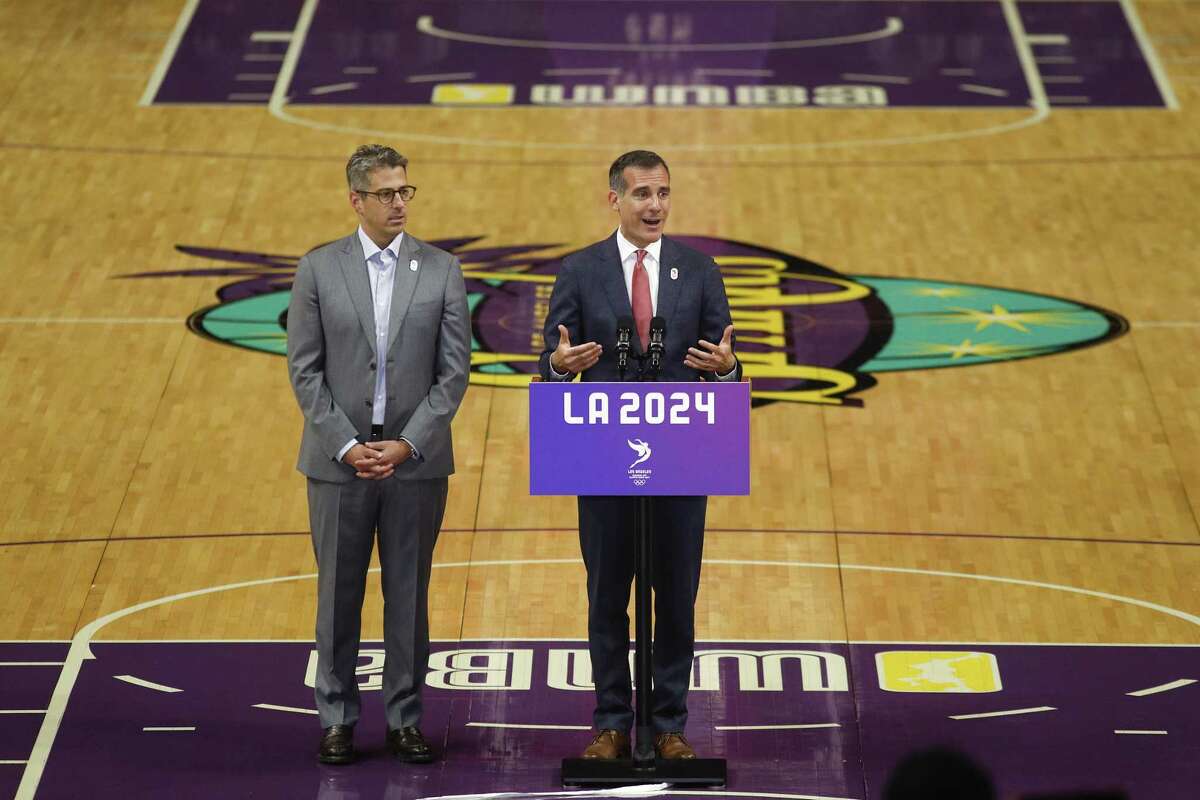 Los Angeles mayor Eric Garcetti, center, speaks as he is joined by Los Angeles 2024 chairman Casey Wasserman during a news conference at Staples Center on May 12, 2017, in Los Angeles. The International Olympic Committee officials wrapped up four days of evaluating Los Angeles’ bid for the 2024 Games before heading to Paris to check the only other candidate.