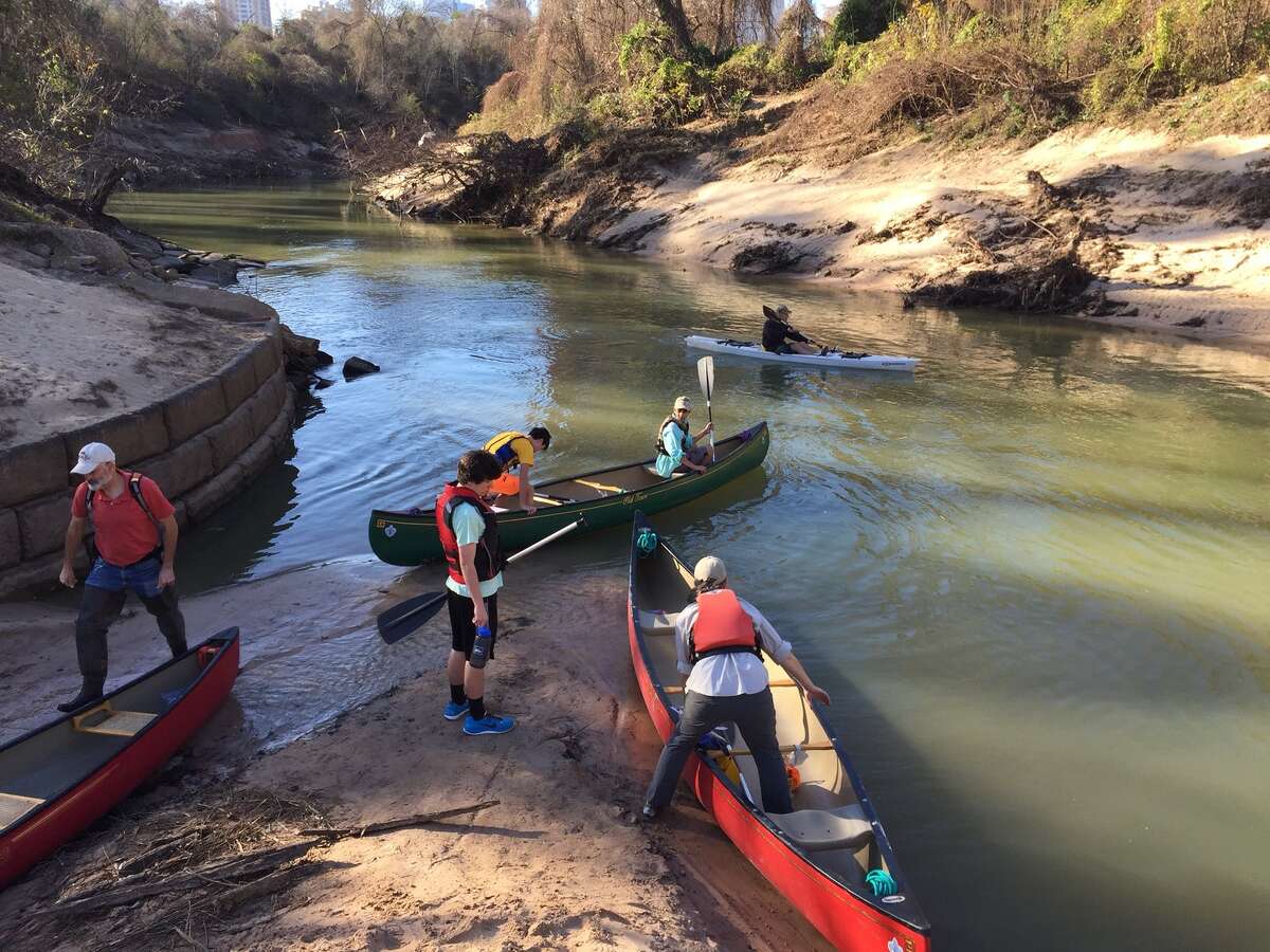 In this photo: Paul Hung and other scouts load into canoes on Buffalo Bayou.