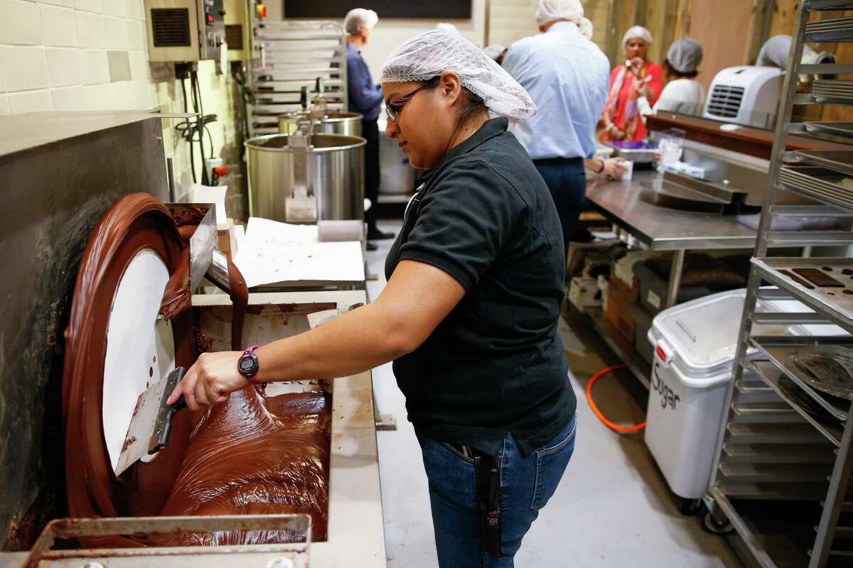 Central Market lead chocolatier Margarita Elizondo tempers chocolate at the Bean to Bar area, where employees turn cacao beans to chocolate.