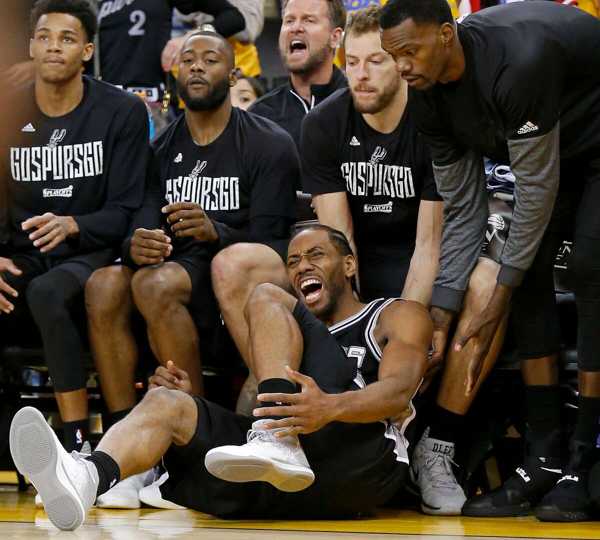 San Antonio Spurs' Kawhi Leonard reacts after being injured on a play during second half action of Game 1 in the Western Conference Finals against the Golden State Warriors Sunday May 14, 2017 at Oracle Arena in Oakland, CA. The Warriors won 113-111.