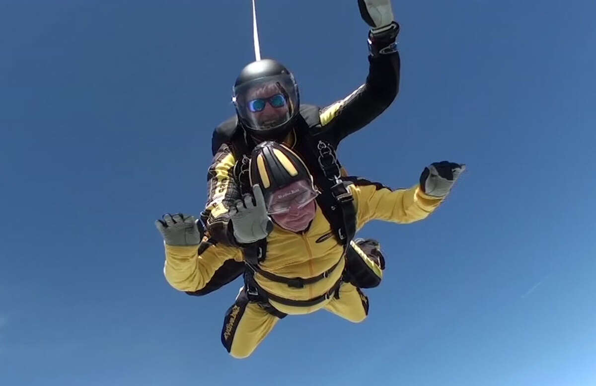Verdun Hayes, in yellow, gestures as he completes a tandem skydive from 15,000 feet at an airfield in Honiton, in southwestern England, on Sunday. The D-Day veteran, who is 101, was accompanied by four generations of his family.