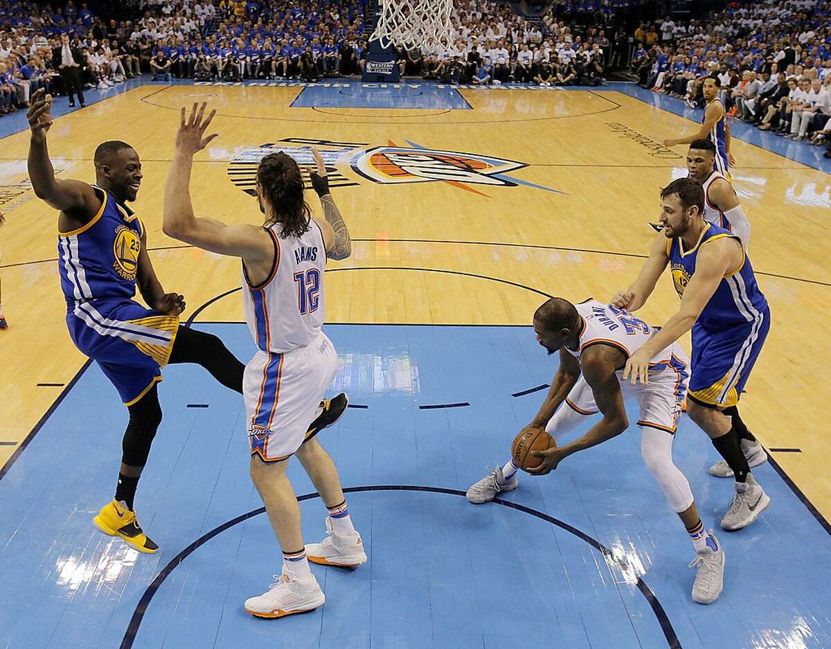 Draymond Green (23) kicks Steven Adams (12) in the groin after Adams fouled him on a shot attempt during the first half as the Golden State Warriors played the Oklahoma City Thunder in Game 3 of the Western Conference Finals at Chesapeake Energy Arena in Oklahoma City, Okla., on Sunday, May 22, 2016.