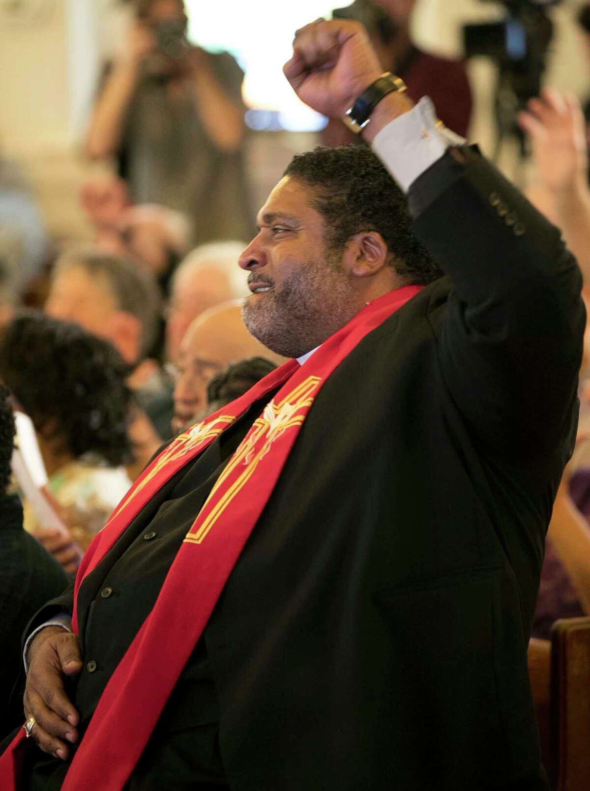 North Carolina NAACP President Rev. William J. Barber II cheers Monday's ruling.