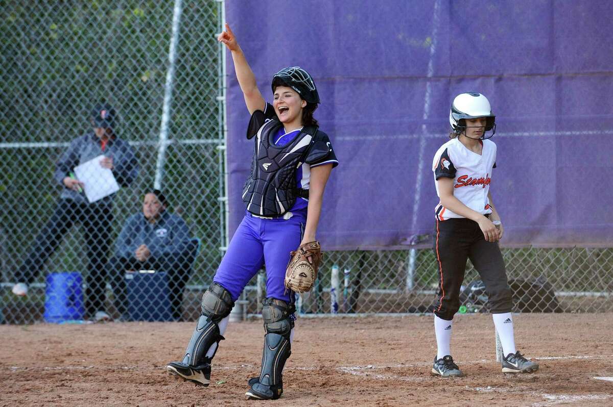 Westhill catcher Jordan Benzaken smiles and cheers for her teammates after Westhill turned a double play against Stamford High during a varsity softball game at Allyson Rioux Field in Stamford, Conn. on Monday, May 15, 2017.