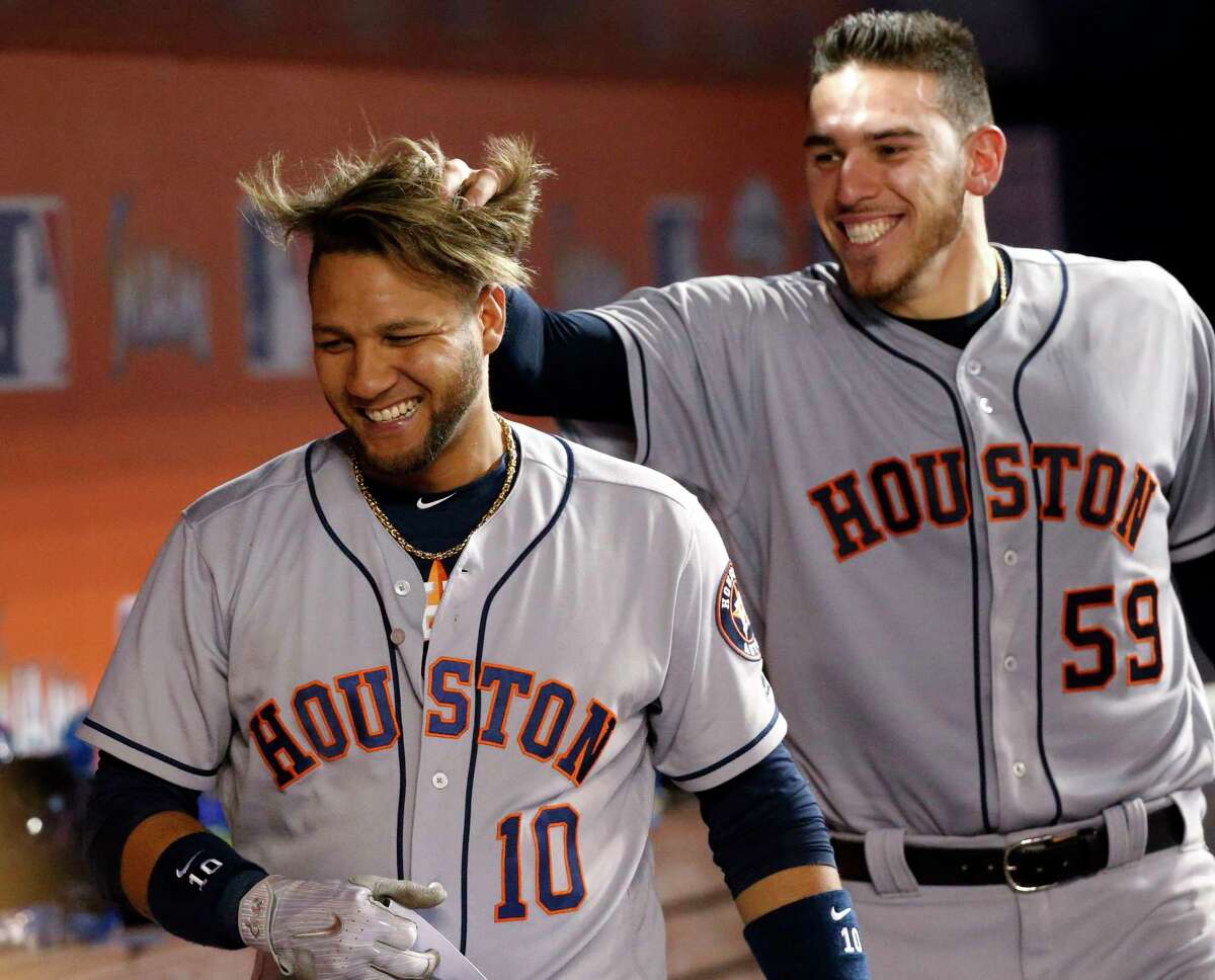 Joe Mus-grove, right, creates a hairy situation for Yuli Gurriel after Gurriel's 6th-inning slam gave the Astros a 3-run lead and set up Musgrove for the win.