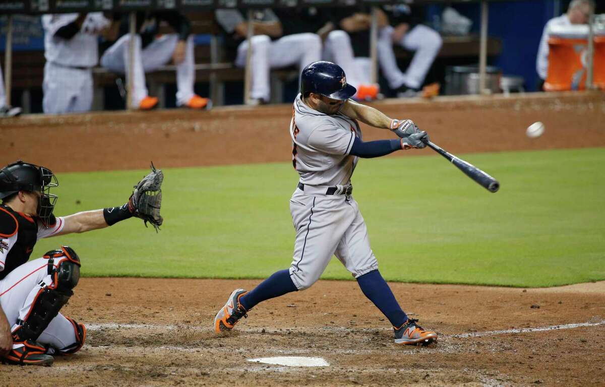 Houston Astros' Jose Altuve hits a home run during the ninth inning of a baseball game against the Miami Marlins, Monday, May 15, 2017, in Miami. The Astros defeated the Marlins 7-2. (AP Photo/Wilfredo Lee)