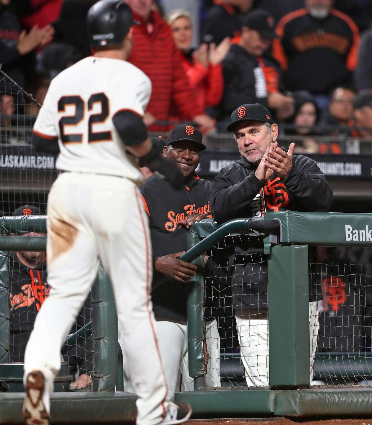 San Francisco Giants' manager Bruce Bochy and batting coach Hensley Muelens welcome Christian Arroyo back to the dugout after he scored on Mac Williamson's RBI single in 6th inning against Los Angeles Dodgers during MLB game at AT&T Park in San Francisco, Calif., on Monday, May 15, 2017.