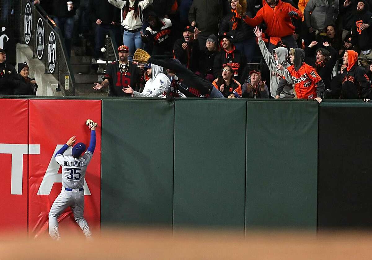San Francisco Giants' Buster Posey's solo home run in 7th inning lands out of reach of Los Angeles Dodgers' Cody Bellinger during MLB game at AT&T Park in San Francisco, Calif., on Monday, May 15, 2017.