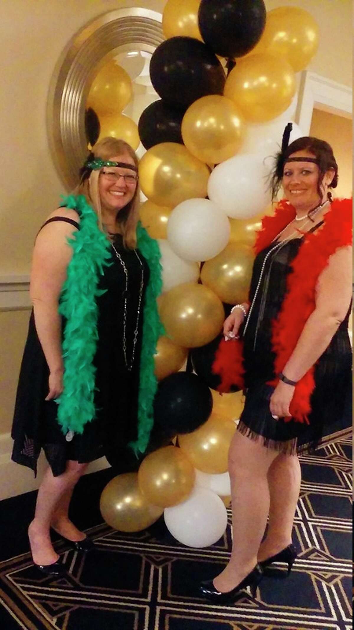 Sarah Hubble, left and Kristin Emerson attend Feathers & Fedoras Friday at the Midland Country Club with a group of eight other friends. The Disability Network of Mid-Michigan drew first-time attendees such as Hubble and repeat attendee Emerson.