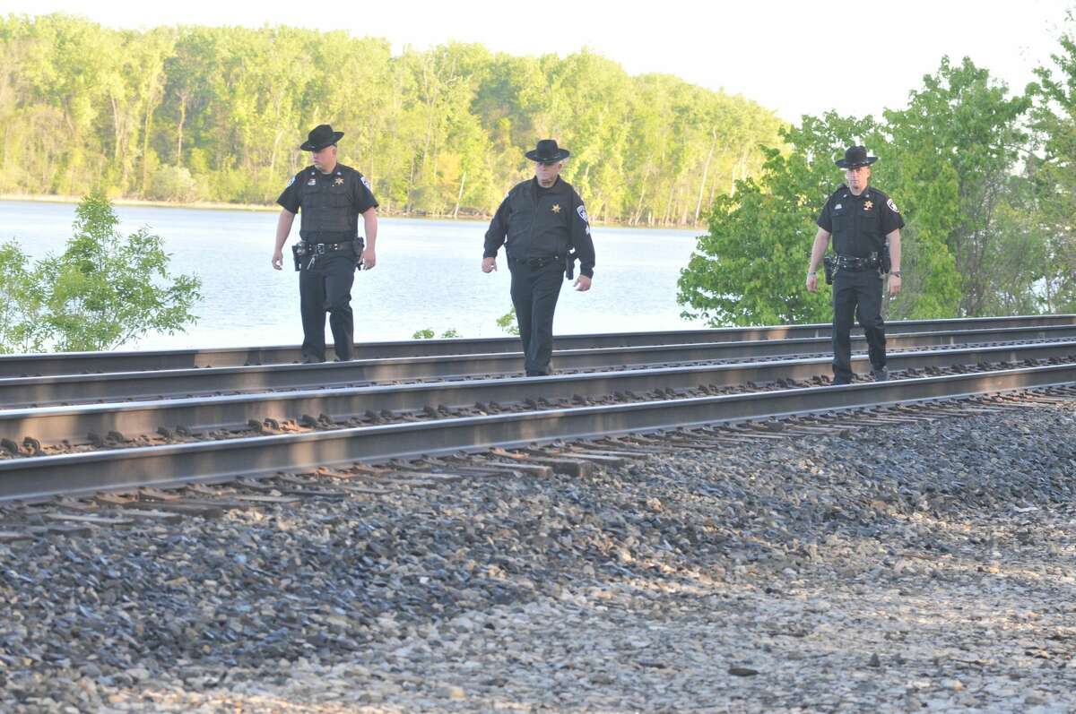Columbia County deputies search the train tracks near the area where, the sheriff's departments says, a man was hit and killed by an Amtrak work train on Tuesday.