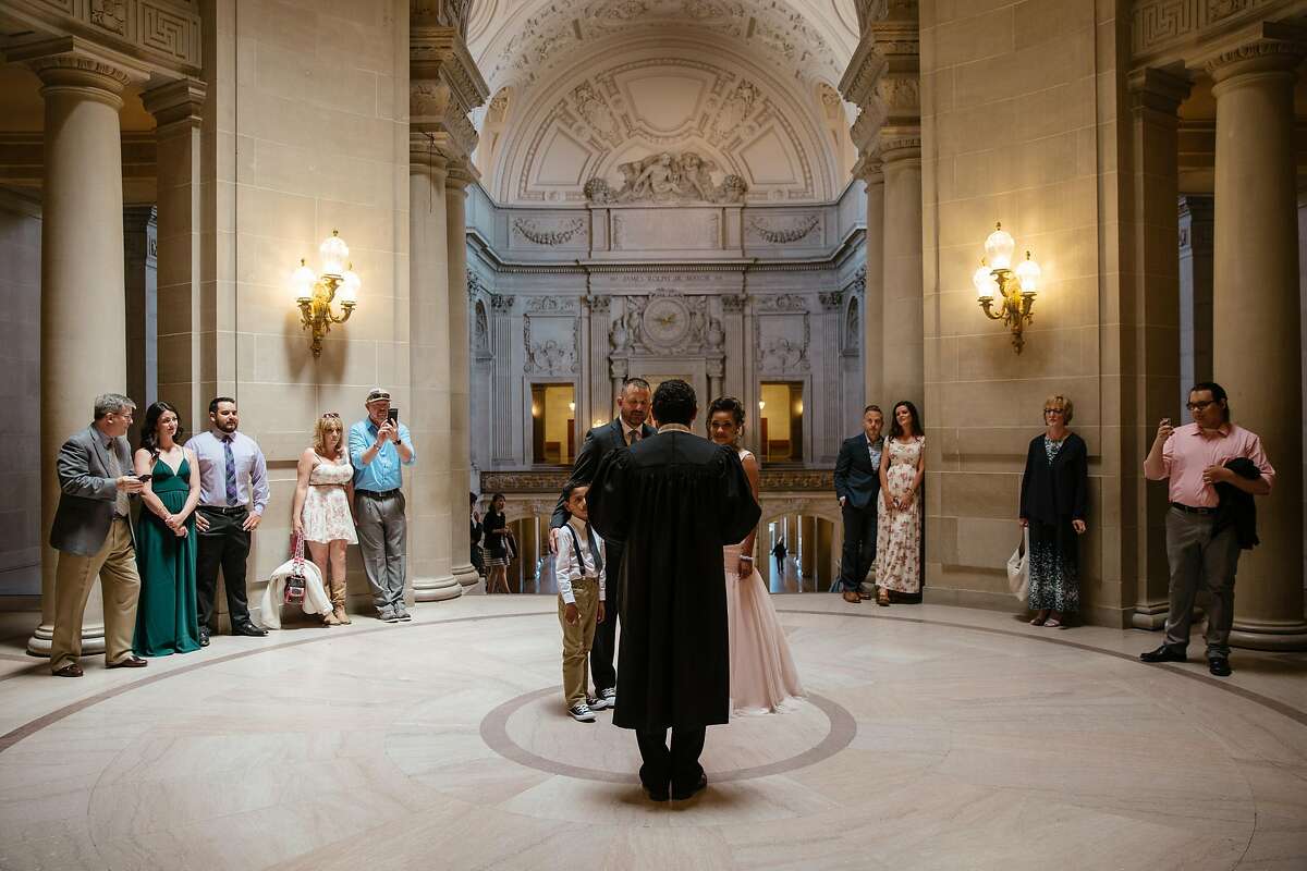 Destiny Cosio, Joshua Sanford, with their daughter, Ava, and son, Noah, surrounded by friends and family at their wedding ceremony at City Hall in San Francisco on May 12th, 2017.