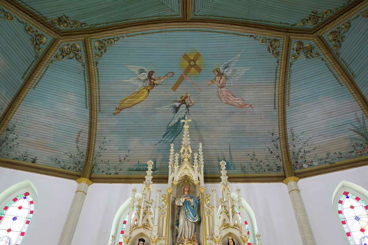 Angels fly above the altar at St. Mary's Church in Praha.