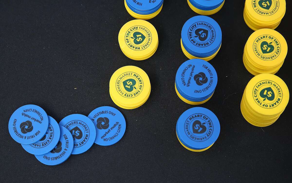 CalFresh food stamp tokens at the Heart of the City Farmer's Market in San Francisco. The Trump administration announced that legal immigrants who use public benefits, including food stamps, may be denied green cards.