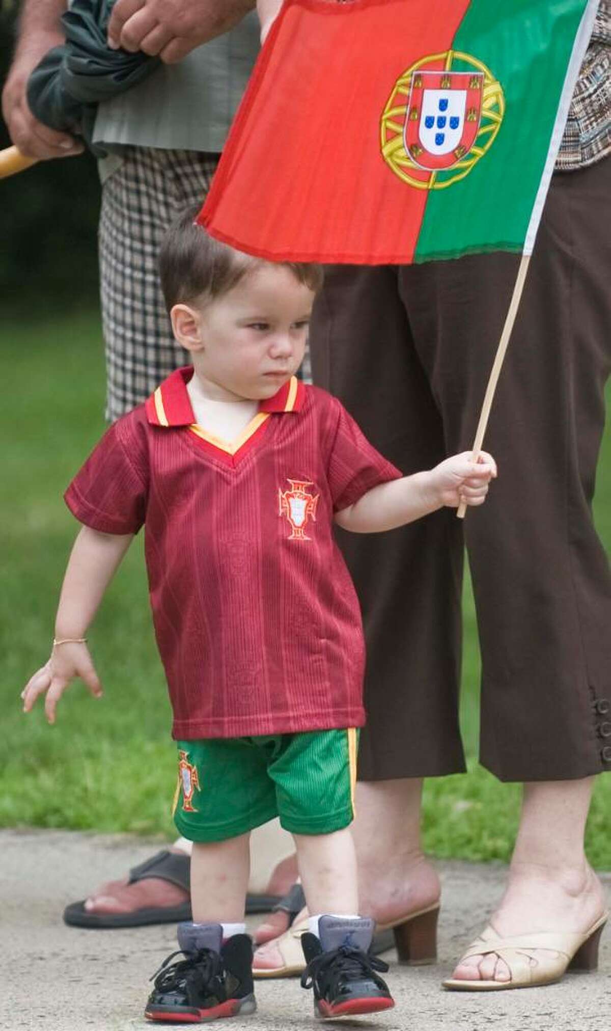 Two year old Christopher Rice of Danbury waves a Portuguese flag during the Dia de Portugal parade on Deer Hill Avenue Sunday, June 6, 2010