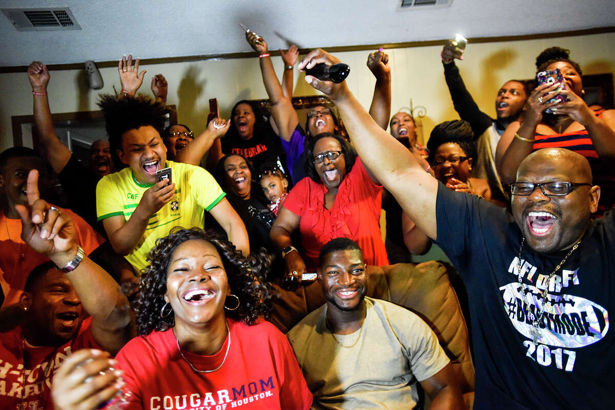 People react as Tyus Bowser's name is announced during an NFL football draft watch party at his family's home in Tyler, Texas, Friday, April 28, 2017. Bowser, bottom center, a Houston linebacker, was selected by the Baltimore Ravens as the 47th pick in the draft. (Chelsea Purgahn//Tyler Morning Telegraph via AP)
