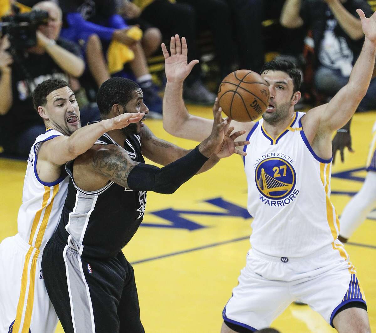 Golden State Warriors' Klay Thompson and Zaza Pachulia guard San Antonio Spurs' LaMarcus Aldridge in the first quarter during Game 2 of the 2017 NBA Playoffs Western Conference Finals at Oracle Arena on Tuesday, May 16, 2017 in Oakland, Calif.