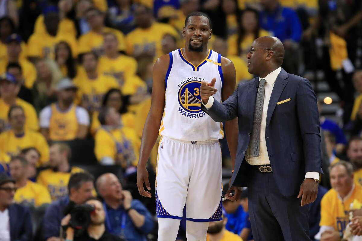 OAKLAND, CA - MAY 16: Kevin Durant #35 of the Golden State Warriors speaks with acting head coach Mike Brown during Game Two of the NBA Western Conference Finals against the San Antonio Spurs at ORACLE Arena on May 16, 2017 in Oakland, California. NOTE TO USER: User expressly acknowledges and agrees that, by downloading and or using this photograph, User is consenting to the terms and conditions of the Getty Images License Agreement. (Photo by Ezra Shaw/Getty Images)