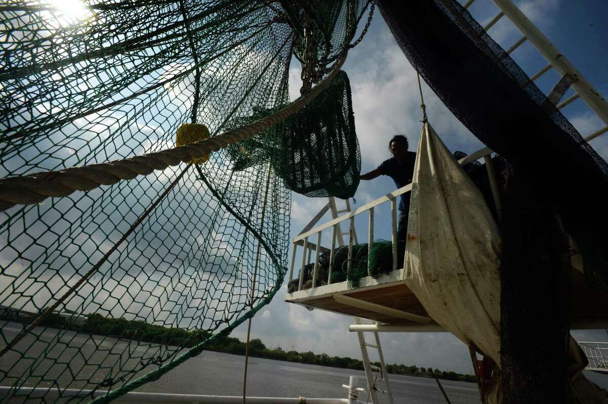 Shrimpers in Port Arthur change out nets Friday morning to switch from shrimping in Texas waters to Louisiana waters. The industry is finding younger generations of workers uninterested in getting into the shrimping business. Photo taken Friday May 12, 2017 Guiseppe Barranco/The Enterprise