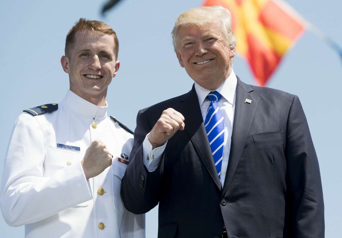 PRESIDENT DONALD TRUMP - US COAST GUARD ACADEMY, 2017 US President Donald Trump gestures with newly-commissioned US Coast Guard Ensign Liam Otto during the US Coast Guard Academy Commencement Ceremony in New London, Connecticut, May 17, 2017.