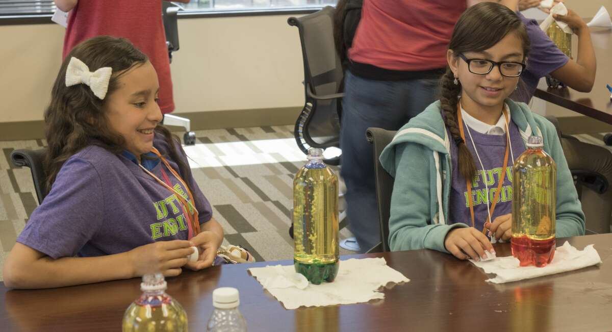 Kaitlyn Cruz and Yvana Garcia react as they watch their home-made lava lamps 5/17/17 at XTO Energy during a girls in engineering program. Tim Fischer/Reporter-Telegram