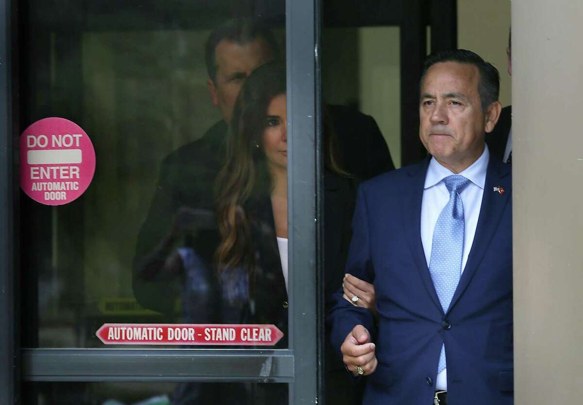 Senator Carlos Uresti, right, walks out of the Federal Courthouse with his wife Lleanna Uresti, left, after being released following his arrest by the FBI on Wednesday, May 17, 2017.