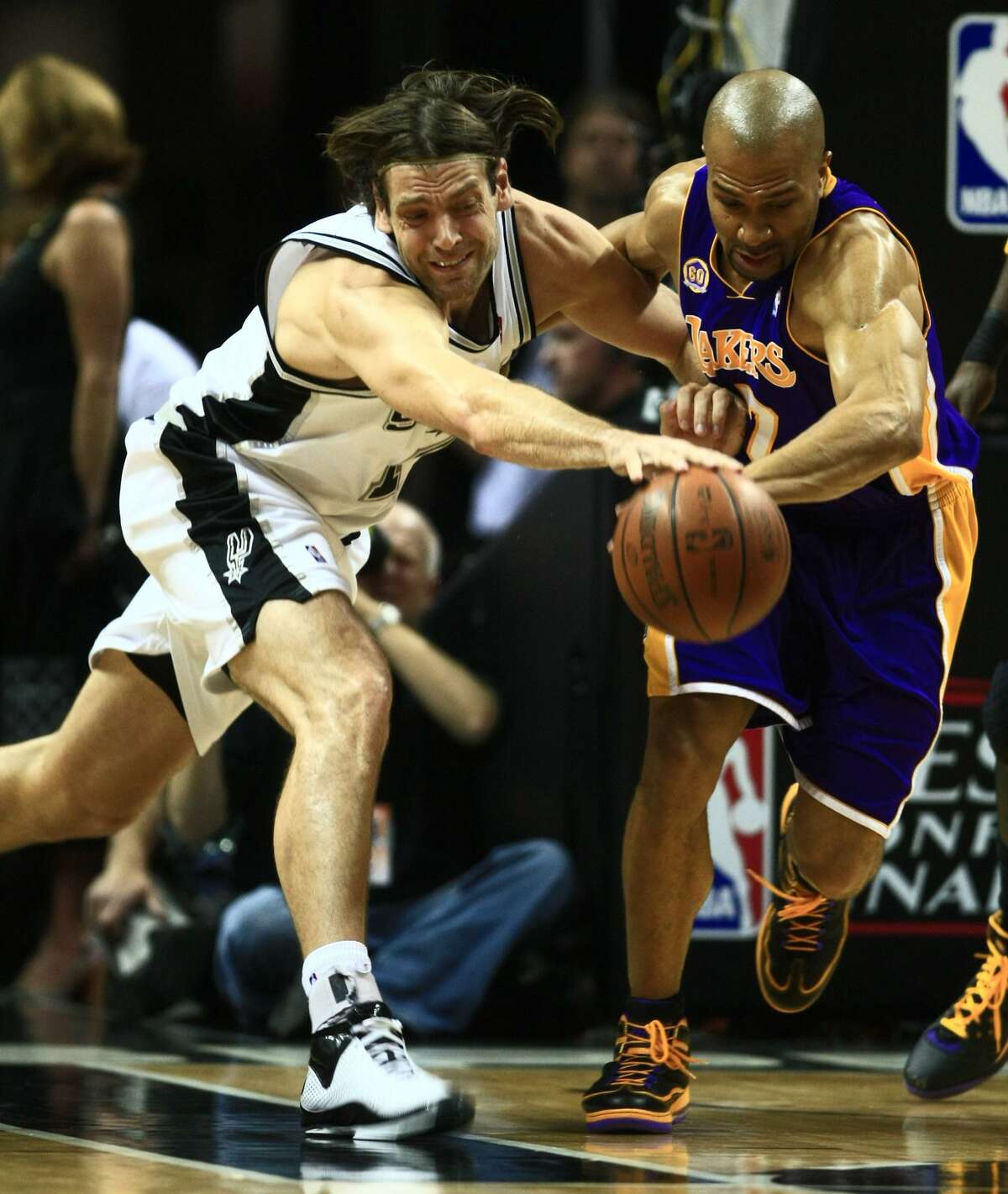 San Antonio Spurs center Fabricio Oberto (7) of Argentina, left and Los Angeles Lakers guard Derek Fisher (2) battle for the loose ball during first half action in game three of the NBA Western Conference Finals Tuesday May 27, 2008. WILLIAM LUTHER