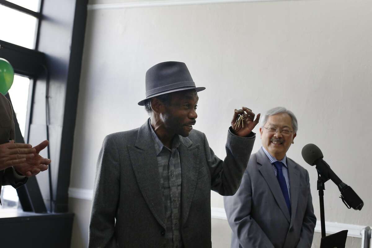 Mayor Ed Lee (right) listens to Joseph Brown (second from right) speak during a press conference at the Winton Hotel announcing a new permanent supportive housing site at the National Hotel on Wednesday, May 17, 2017 in San Francisco, Calif. Brown is formerly homeless and moved into his new home at the Winton, which has been in operaton since the fall, on December 30, 2016.