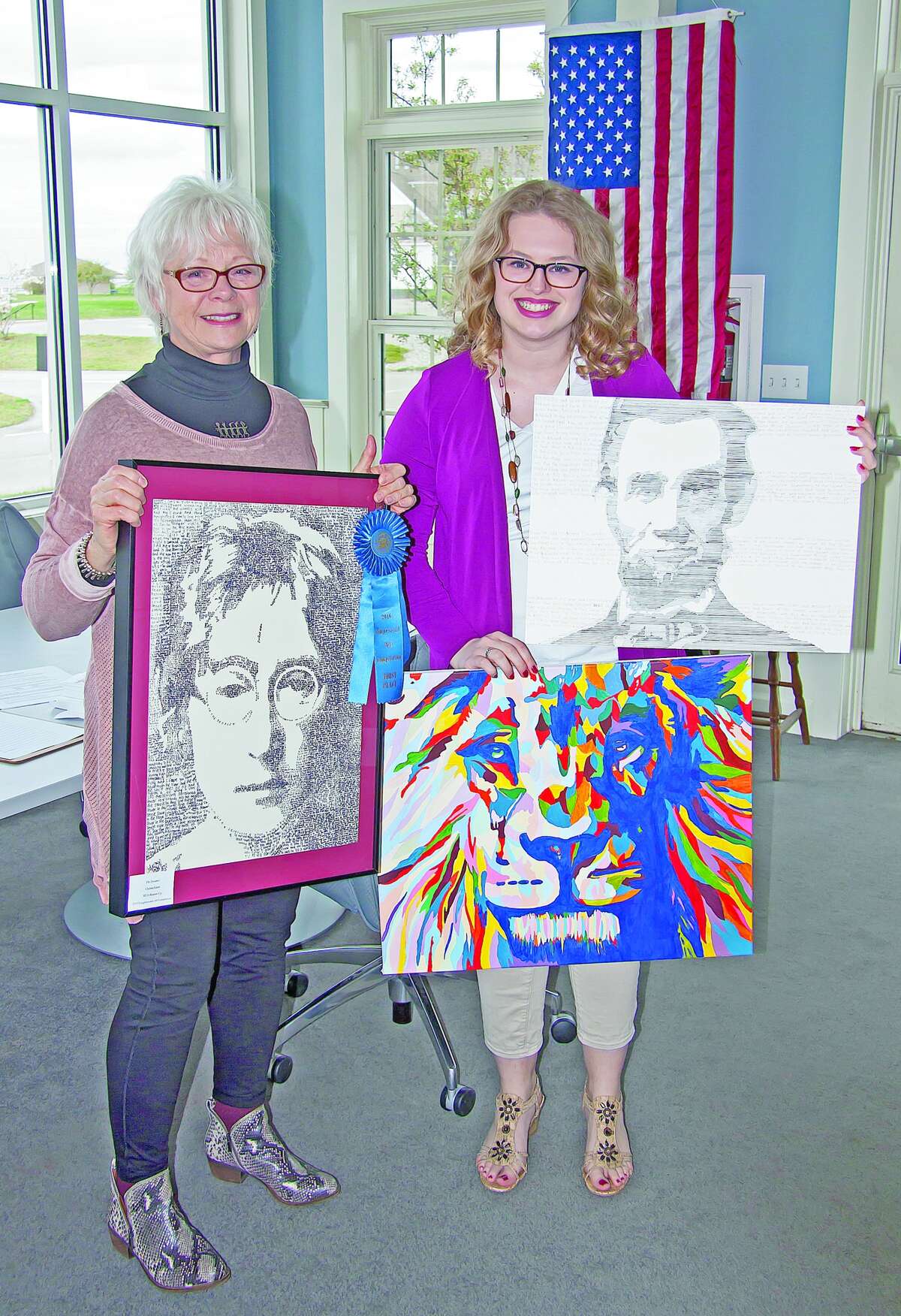 Chelsea Faber and TAG President Donna McCatty display an assortment of Faber’s work, including a portrait of musician/singer John Lennon.