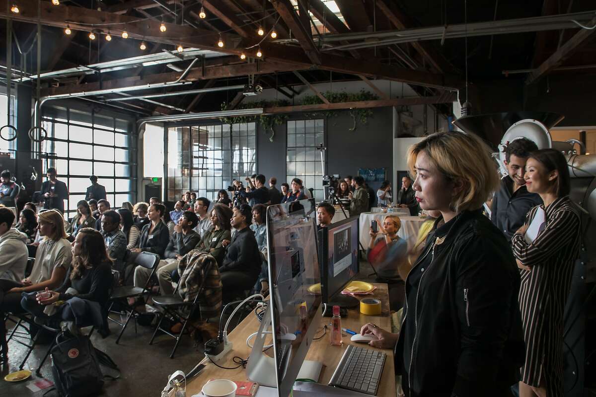 Theresa Phung, Wefunder's Chief Storyteller, along with Omar Shammas and Jiwon Moon, also of the company, watch two companies make their pitches at an event held at Red Bay Coffee on Wednesday, May 17, 2017 in Oakland, Calif. Moon said about 125 people attended the event.