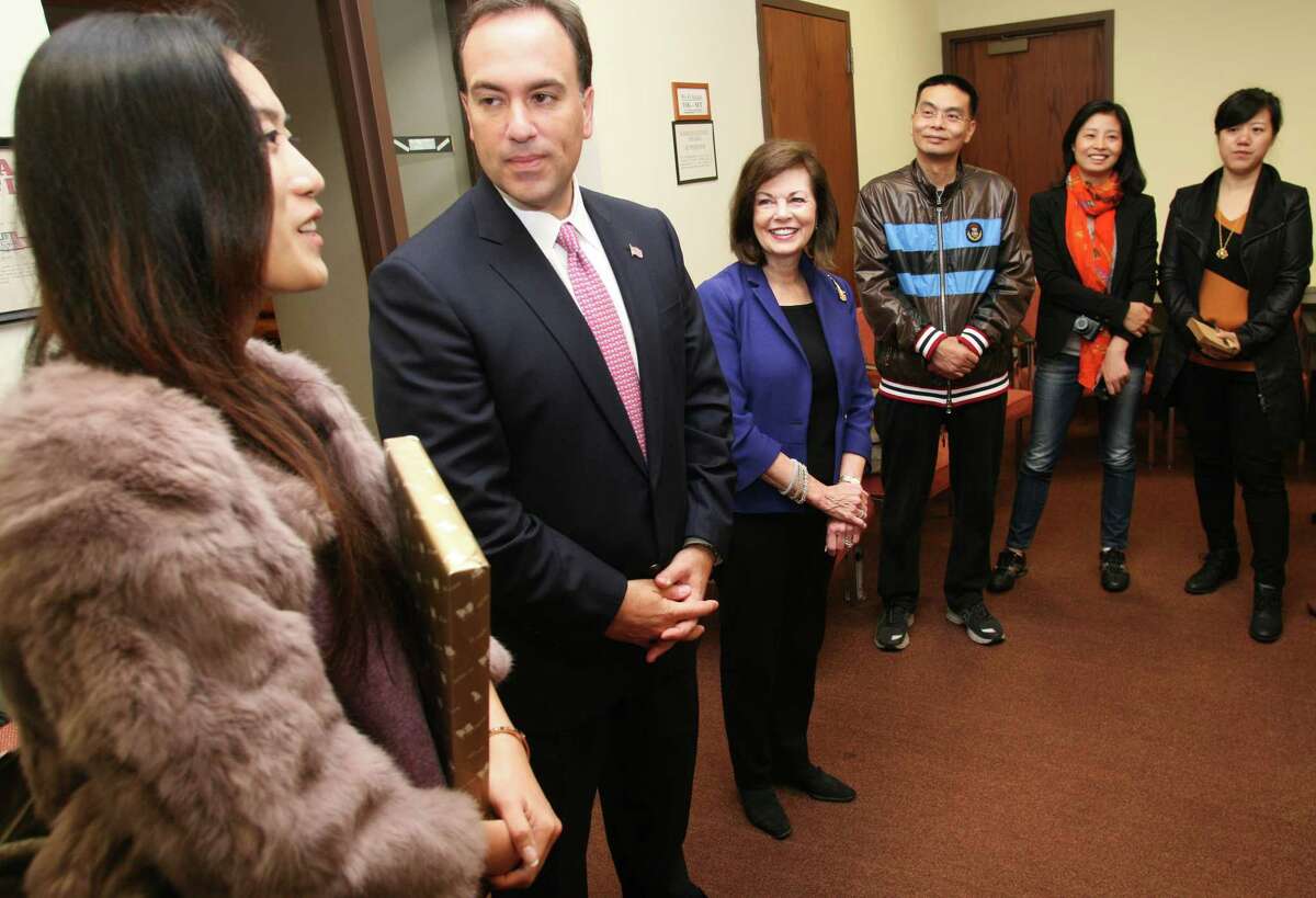 First Selectman Peter Tesei, second from left, listens to translator Wendy Hua, left, during a visit to Town Hall by sixteen Chinese journalists here to get a better understanding of Greenwich as a financial center, commuting base to NYC, and a residential center Friday, Nov. 1, 2013.