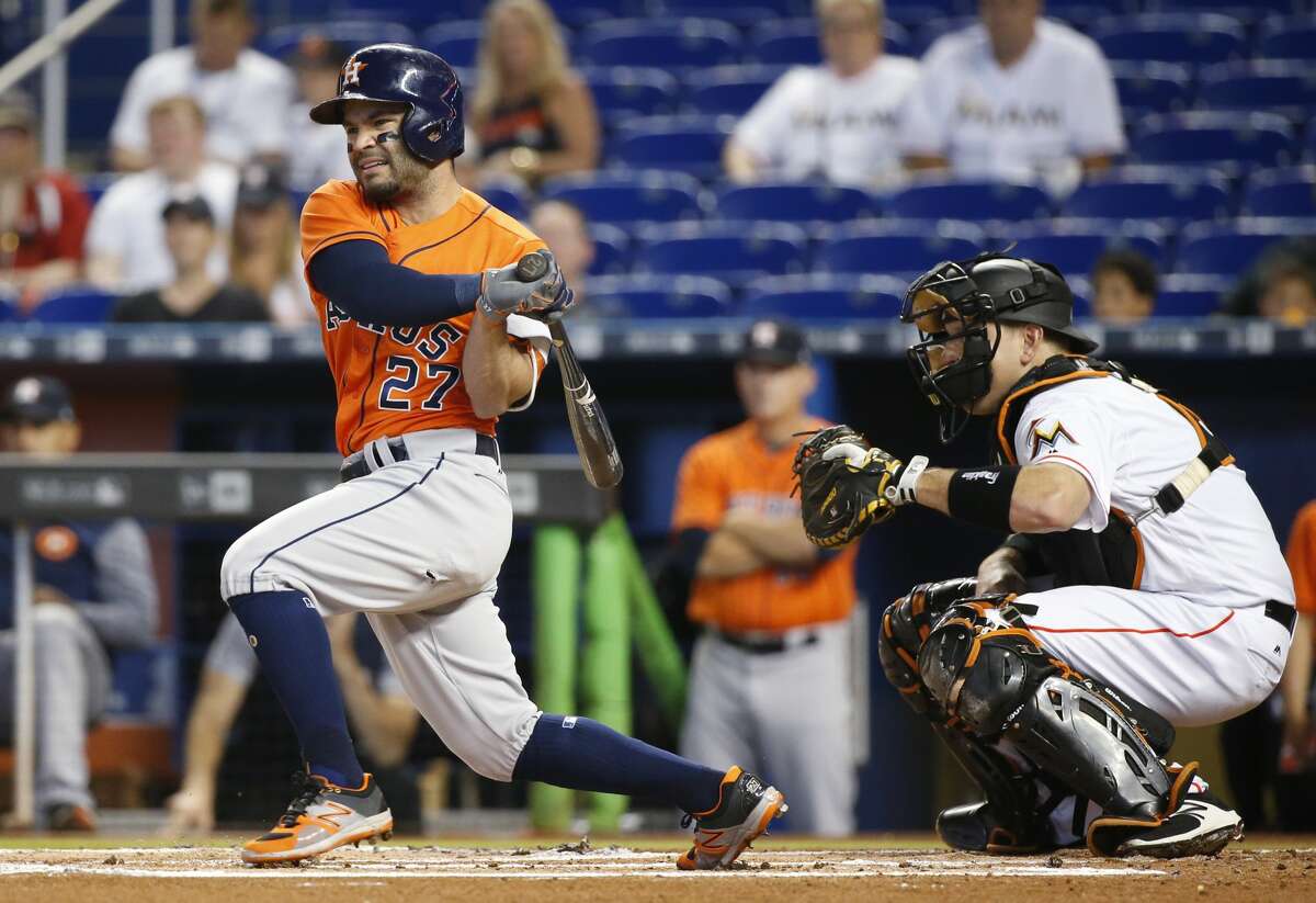Houston Astros' Jose Altuve hits an RBI double scoring George Springer during the first inning of a baseball game against the Miami Marlins, Wednesday, May 17, 2017, in Miami. (AP Photo/Wilfredo Lee)