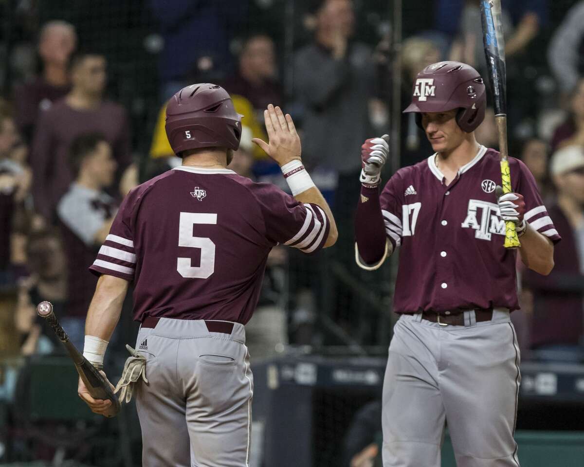 Texas A&M 's Logn Foster (5) Joel Davis (17) celebrate after Foster scored during a NCAA baseball game at Minute Maid Park on Sunday, Mar. 5, 2017, in Houston. (Joe Buvid / For the Houston Chronicle)