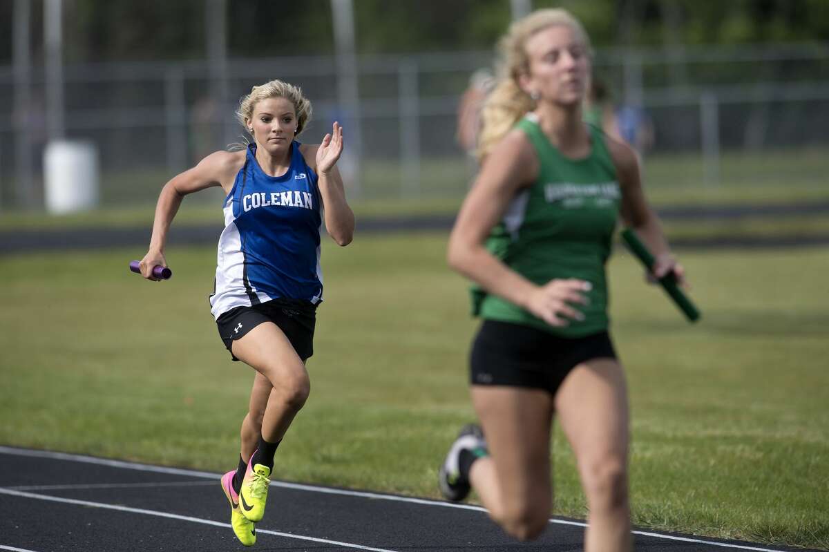 Coleman's Makailyn Monson, left, closes the gap between her and Houghton Lake's Bridget Ripke during the last leg of the 4x100 relay during a Wednesday afternoon track meet.