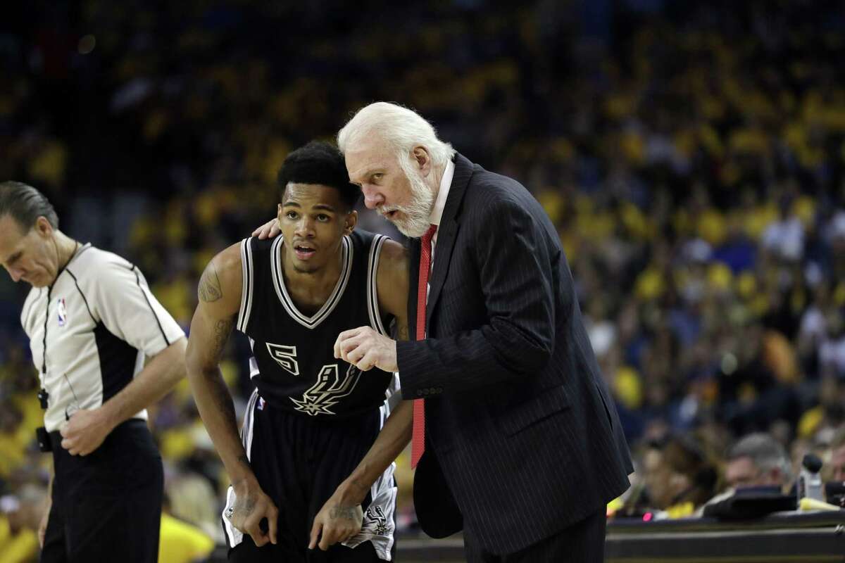 Gregg Popovich (right) talks to guard Dejounte Murray in the second hald Tuesday. Murray finished with eight points.