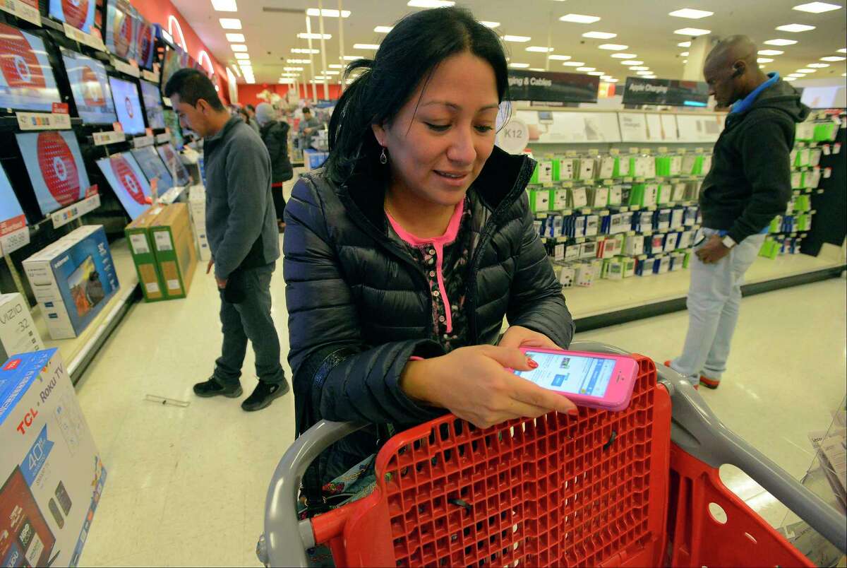 Famny Rojas of Stamford, Conn., shops in a Target and checks competitors' pricing online before making her TV purchase in November. ﻿
