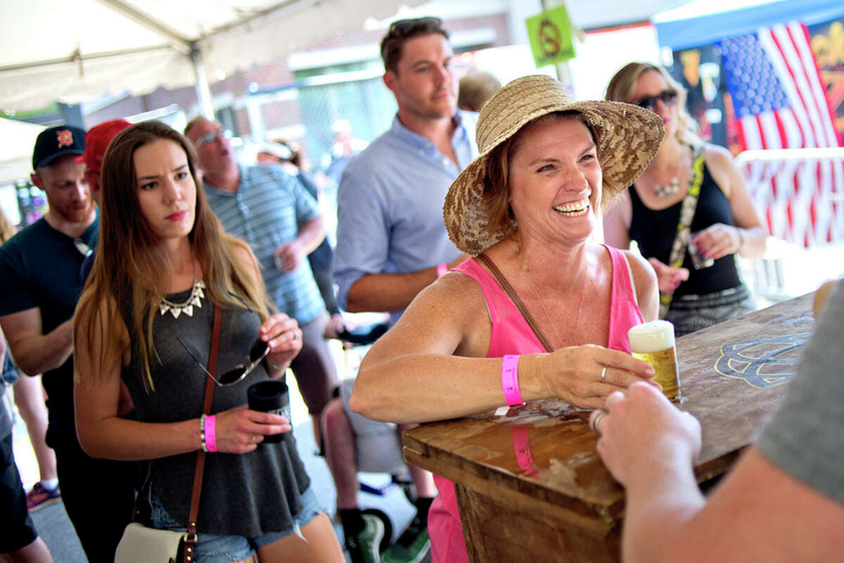 Liz Seelhoff smiles while being served a beer during Tapped in this 2016 file photo.