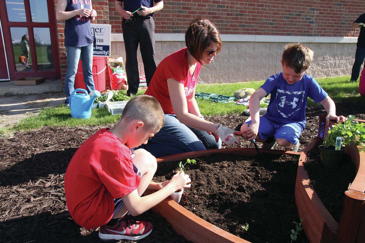 First graders at Unionville-Sebewaing Area Elementary School planted a raised garden Thursday morning with supplies donated by Gleaner Life Insurance Society, USA Arbor of Sebewaing.