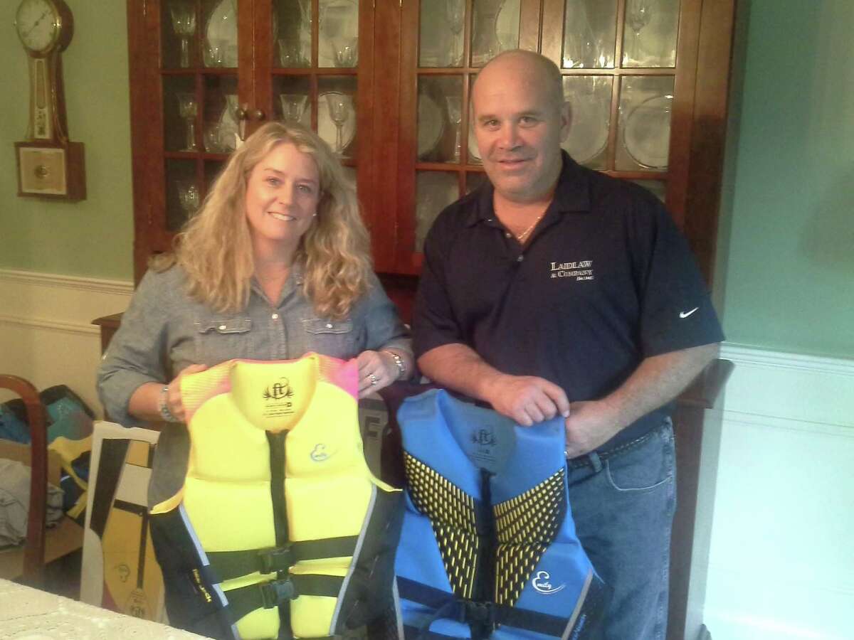 Pamela and Joe Fedorko show off life vests which will be given out to participants in Sunday s Emsway Walk for Boating Safety at Greenwich Point.