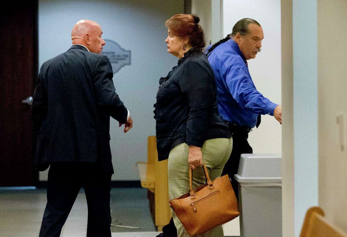 Herman Hoffman, right, is seen beside her his wife Kathleen, center, and their lawyer Bill Power during a court recess as the jury deliberates whether or not to convict the couple with five Class A misdemeanors of cruelty to non-livestock animals each in Judge Dennis Watson's County Court-at-Law 1, Thursday, May 18, 2017, in Conroe.