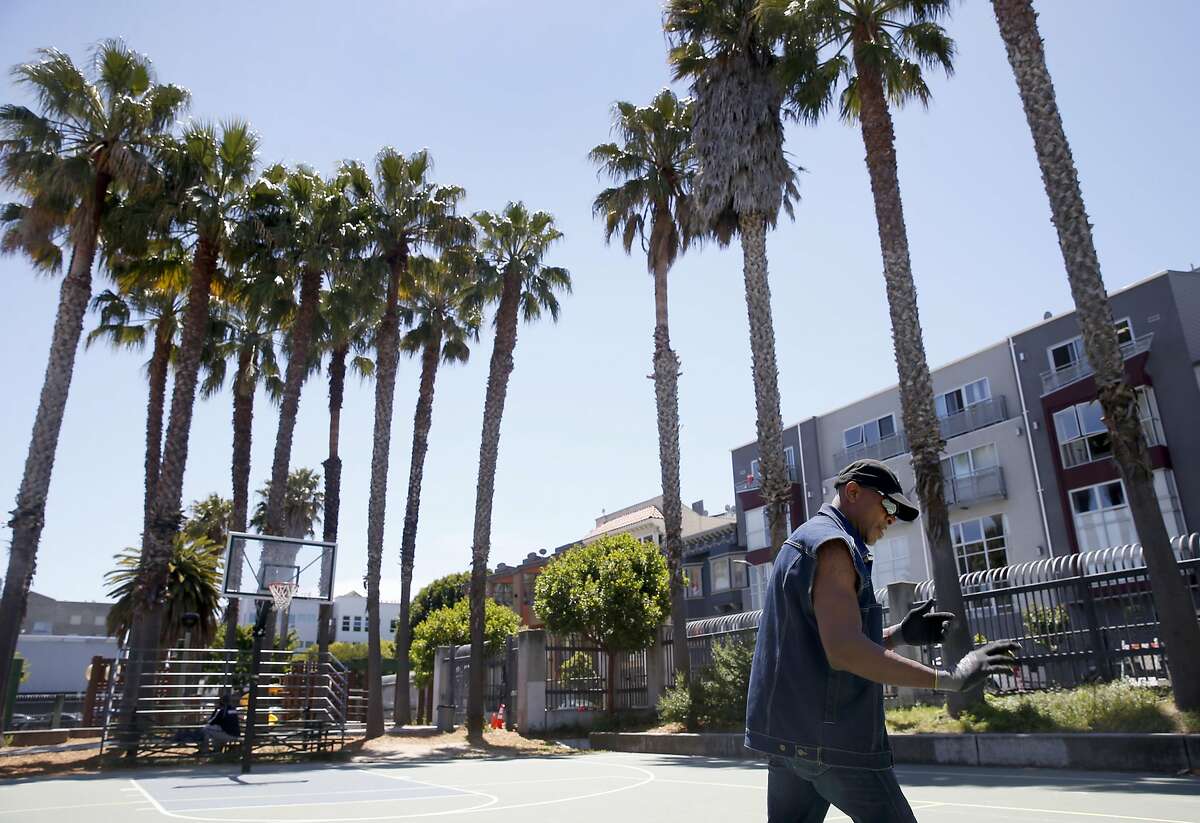 Clyde McCoy Jr. throws a ball against the wall on the Gene Friend Recreation Center playground at Folsom and Sixth streets across from where proposed high-rise developments would cast shadows on it.