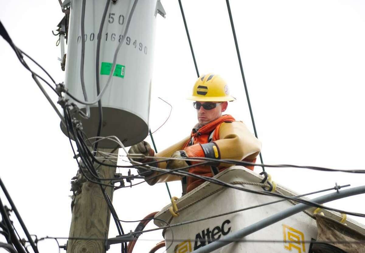 Matt Hand, of Torrington, a lineman for Asplundh, a CL&P contractor, repairs a transformer on Hubbard Ave. in Stamford, Conn. on Monday, March 15, 2010.