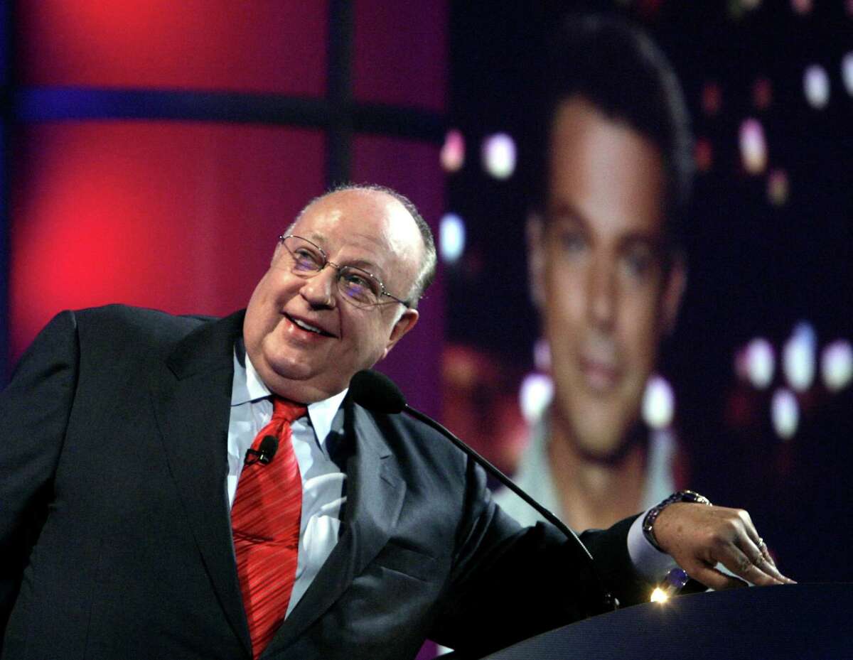 FILE - In this July 24, 2006 file photo, Roger Ailes, chairman and chief executive officer of Fox News, listens as anchor Shepard Smith, seen on screens in front and behind him, as Smith talks to the audience via satellite from Israel, at the Summer Television Critics Association Press Tour in Pasadena, Calif. Fox News said on Thursday, May 18, 2017, that Ailes has died. He was 77. (AP Photo/Reed Saxon)